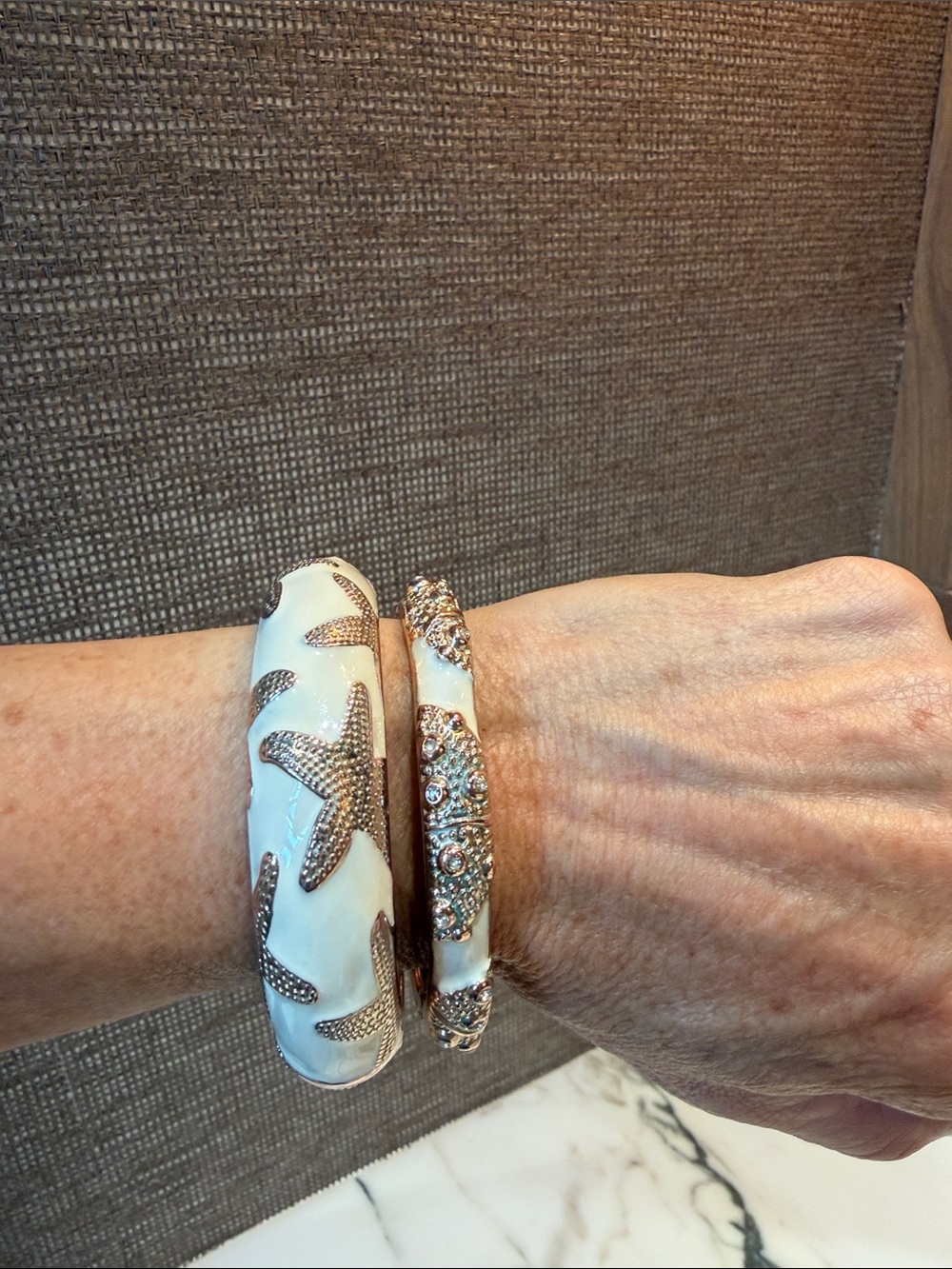 White enamel Bangle Bracelet with Textured gold tone Starfish Accents
